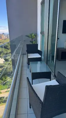 a balcony with tables and chairs on a building at Torre Puerta el Alma-Luxury Stay-Frente Mall Multiplaza in Ceiba de Guadalupe
