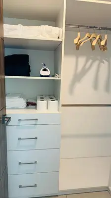 a closet with white drawers and shoes in it at Torre Puerta el Alma-Luxury Stay-Frente Mall Multiplaza in Ceiba de Guadalupe