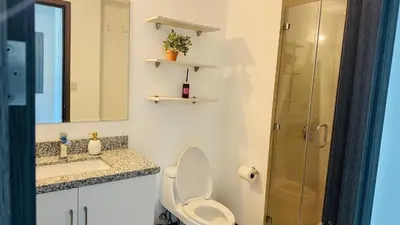 a bathroom with a toilet and a sink and a shower at Torre Puerta el Alma-Luxury Stay-Frente Mall Multiplaza in Ceiba de Guadalupe