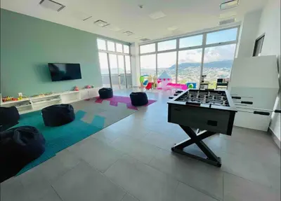 a living room with a piano in a room with windows at Torre Puerta el Alma-Luxury Stay-Frente Mall Multiplaza in Ceiba de Guadalupe