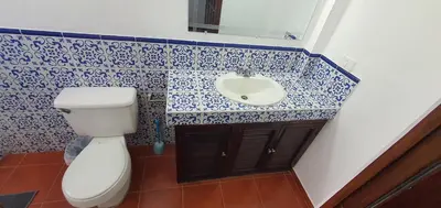 a bathroom with a toilet and a sink at Townhouse San Benito, La Mascota Terra in San Salvador