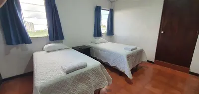a room with two beds and a window at Townhouse San Benito, La Mascota Terra in San Salvador