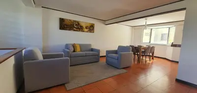 a living room with a couch and chairs and a table at Townhouse San Benito, La Mascota Terra in San Salvador
