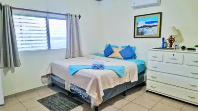 a bedroom with a bed with a blue bow on it at Casa Libre Guest House in Conchagua