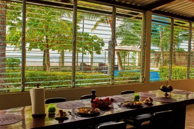 a dining room with a table with food on it at Casa Libre Guest House in Conchagua