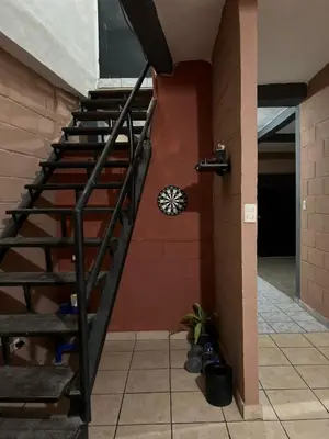 a spiral staircase in a building with a wall at Hostal Casa compartida a 8 mins de San Salvador in San Salvador