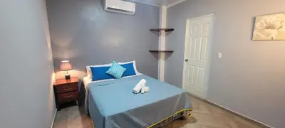 a bedroom with a blue bed with a stuffed animal on it at Villa Costabay in El Zapote