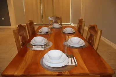 a wooden table with plates and dishes on it at Villa Costabay in El Zapote