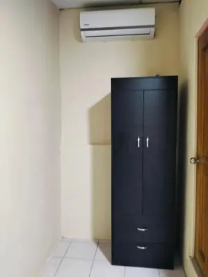 a black cabinet in the corner of a room at Habitacion con aire acondicionado in San Salvador