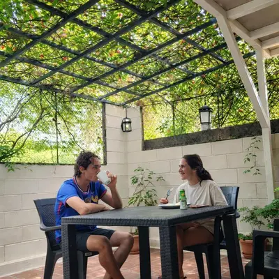 a man and a woman sitting at a table at Habitacion con aire acondicionado in San Salvador