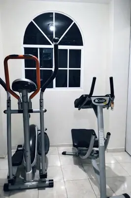 a gym with two exercise bikes and a window at Habitacion con aire acondicionado in San Salvador