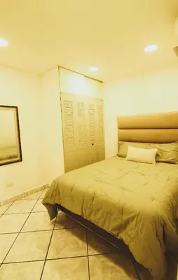 a bedroom with a bed in a room at Spacious Home - Cerca de Escalón in San Salvador
