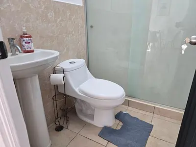 a bathroom with a toilet and a sink and a shower at San Francisco IV in San Miguel