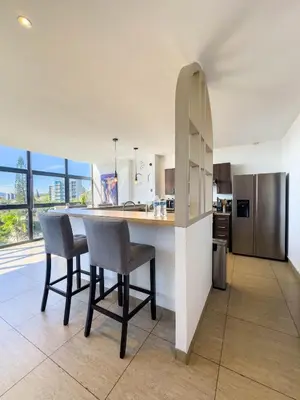 a kitchen with a table and chairs in a kitchen at Anthonini's Apartment 6 guests San Salvador in San Salvador