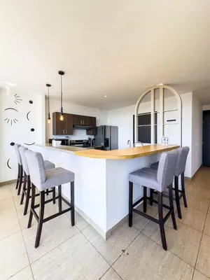 a kitchen with a counter with chairs around it at Anthonini's Apartment 6 guests San Salvador in San Salvador
