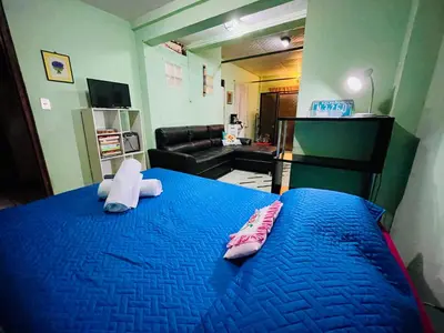 a bedroom with a blue bed with two pillows on it at Habitación privada en villa familiar en La Libertad in Zaragoza