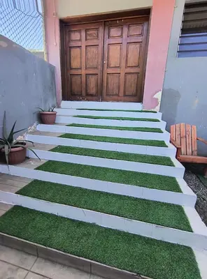 a set of stairs with grass in front of a door at Apartment in Playa Las Flores La Libertad in La Libertad
