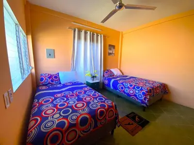 a bedroom with two beds and a window at Casa Acogedora