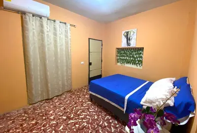 a bedroom with a blue bed and a window at Casa Acogedora