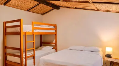 a bedroom with two bunk beds and a ladder at Villa Con Piscina, Playa, Jacuzzi, Kayaks in Conchagua