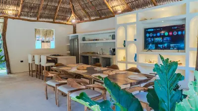 a dining room with a table and chairs and a bar at Villa Con Piscina, Playa, Jacuzzi, Kayaks in Conchagua