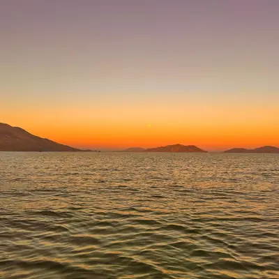 a sunset over the water with mountains in the background at Villa Con Piscina, Playa, Jacuzzi, Kayaks in Conchagua