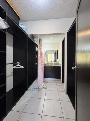 a bathroom with black cabinets and a tile floor at Apartment in Colonia Escalón with pool and gym in San Salvador