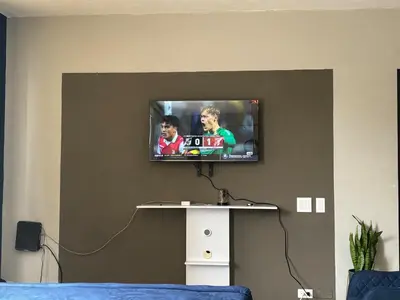 a television on a wall in a room at Apartment in Colonia Escalón with pool and gym in San Salvador