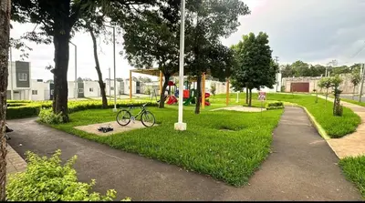 a bike parked on the grass in a park at The small house in Ahuachapán