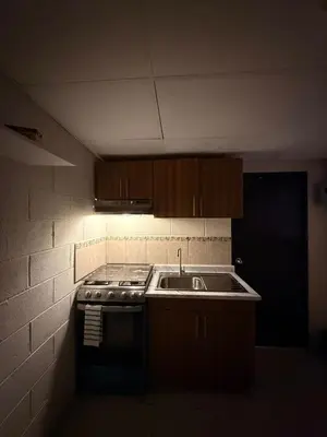 a kitchen with a stove and a sink in it at El Pibe
