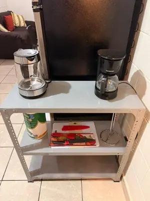 a small white table with a blender and a coffee maker at El Pibe