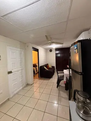 a kitchen with a refrigerator and a living room at El Pibe