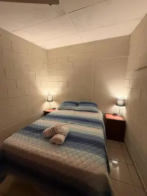 a bed with a towel laying on it in a room at El Pibe