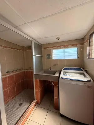 a small bathroom with a sink and a washing machine at El Pibe