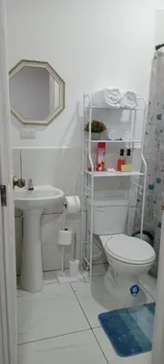 a bathroom with a toilet and a sink and a mirror at El Sunzal Azul in El Sunzal