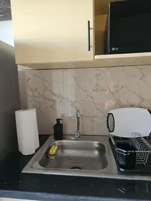 a kitchen sink with a dish drying rack next to it at Casa Márquez in San Miguel