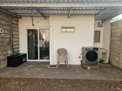 a patio with a stove and a chair in front of a house at Casa Márquez in San Miguel