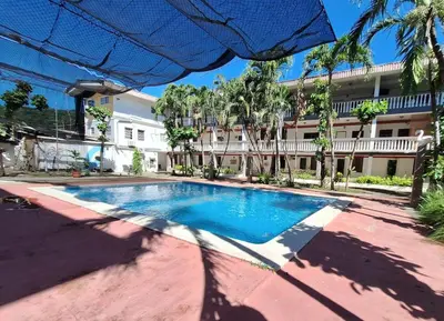 a swimming pool in front of a building at Surfcity - AC - WiFi - Coastal Paradise SV in La Libertad