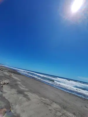 a beach with the ocean and the sun in the sky at Surfcity - AC - WiFi - Coastal Paradise SV in La Libertad