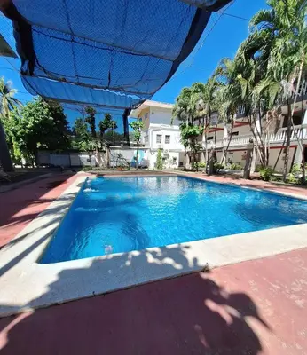 a swimming pool in front of a house at Surfcity - AC - WiFi - Coastal Paradise SV in La Libertad