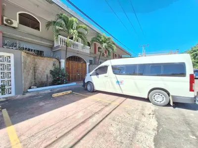 a white van parked in front of a building at Surfcity - AC - WiFi - Coastal Paradise SV in La Libertad