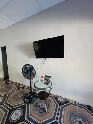 a room with a table and a tv on a wall at Agradable vivienda vacacional in Suchitoto