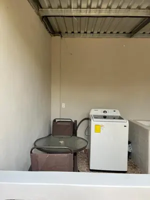 a small room with a table and a small refrigerator at Pleasant Vacation Home in Suchitoto