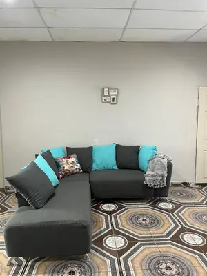 a living room with a black couch on a rug at Pleasant Vacation Home in Suchitoto