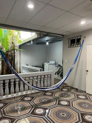 a hammock in a room with a floor at Pleasant Vacation Home in Suchitoto