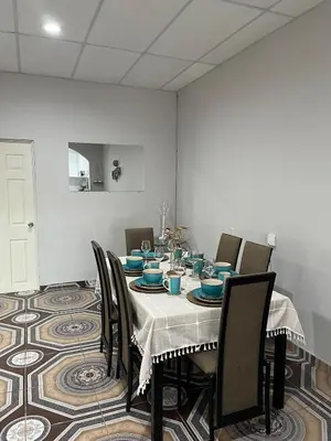 a dining room with a table with blue dishes on it at Pleasant Vacation Home in Suchitoto