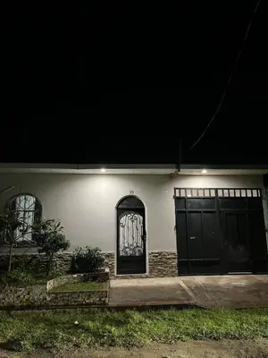 a white house with a door with a painting on it at Pleasant Vacation Home in Suchitoto