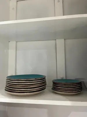 two stacks of plates sitting on a shelf in a kitchen at Pleasant Vacation Home in Suchitoto