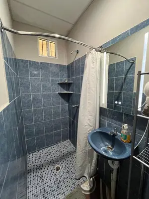 a bathroom with a shower and a sink at Pleasant Vacation Home in Suchitoto
