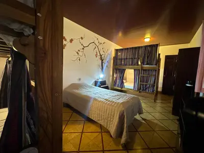 a bedroom with a bed and a book shelf at Neska Polita Hostel in Juayúa